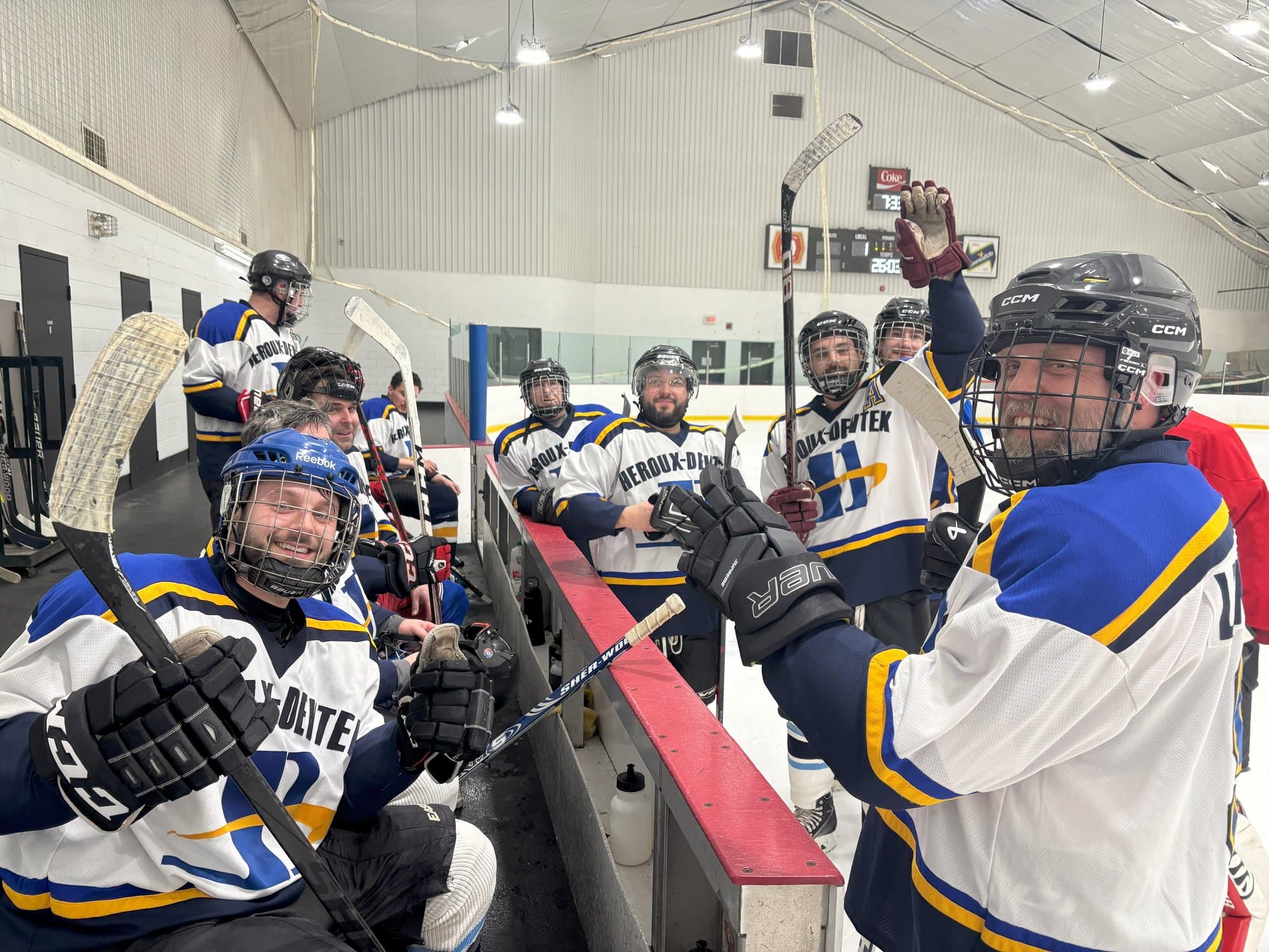 Players celebrating on the bench after a goal